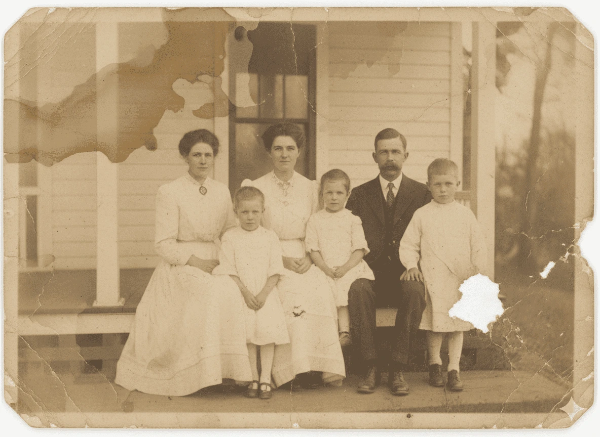 Heavily faded old photo of a family of six on a porch with a water stain